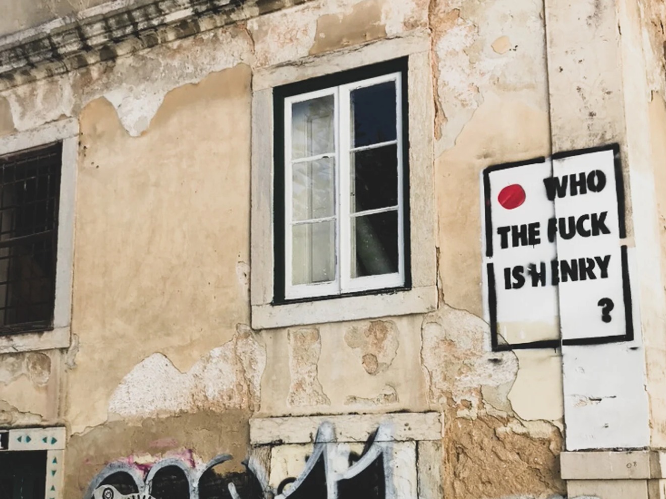 'Who the fuck is Henry?' poster pasted on a building wall