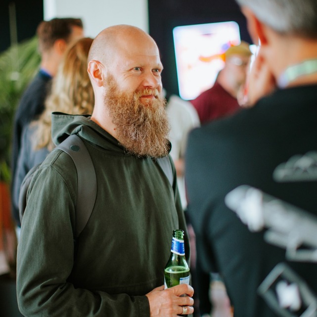 A visitor at the event holding a drink