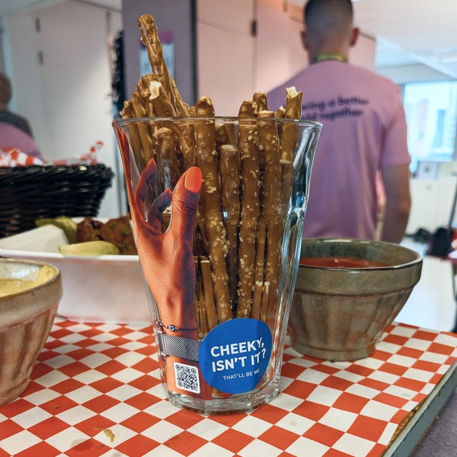 A campaign sticker on a glass of breadsticks on a checkered table